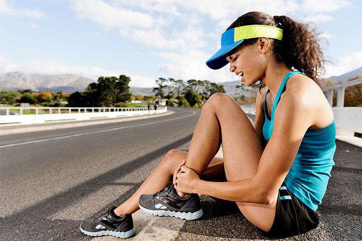 Female runner feeling an injury in her foot